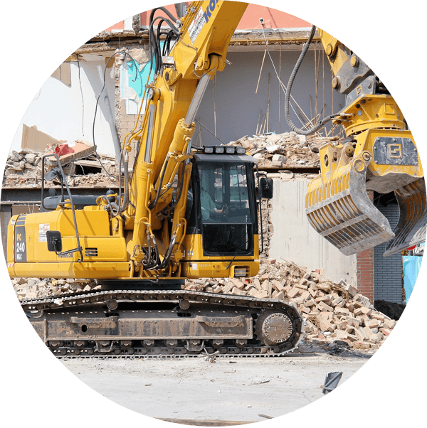backhoe clearing debris during demolition